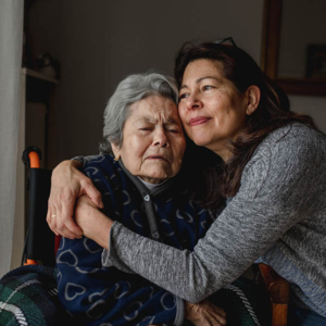 daughter hugging senior mother